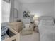 Well-lit bedroom with a crib, a dresser, and a cozy armchair, perfect for a baby's Bedroom at 3502 E Hazeltine Way, Queen Creek, AZ 85142