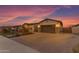 Spacious, brick paver driveway leading to a two-car garage surrounded by desert landscaping and a charming home at 3502 E Hazeltine Way, Queen Creek, AZ 85142