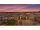 Charming home featuring landscaped yard, desert plants, a brick driveway, and a two car garage under a colorful sunset at 3502 E Hazeltine Way, Queen Creek, AZ 85142