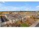 Stunning exterior view of a desert home featuring a paver driveway, lush landscaping and vibrant flowering shrubs at 3502 E Hazeltine Way, Queen Creek, AZ 85142