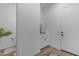 Bright hallway featuring a small powder room, a hall closet, and lots of natural light at 3502 E Hazeltine Way, Queen Creek, AZ 85142