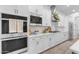 A modern kitchen featuring white cabinets, built in microwave and oven, and quartz counters at 3502 E Hazeltine Way, Queen Creek, AZ 85142