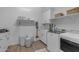 Well-lit laundry room with ample cabinet space, utility sink, washer, dryer and decorative storage baskets at 3502 E Hazeltine Way, Queen Creek, AZ 85142
