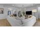Bright living room featuring a large sectional sofa, entertainment center and an open-concept layout at 3502 E Hazeltine Way, Queen Creek, AZ 85142