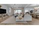 Bright living room showcasing an oversized sectional sofa, decorative chandelier and access to the outdoor space at 3502 E Hazeltine Way, Queen Creek, AZ 85142