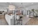 Bright living room featuring a large sectional sofa and an open-concept layout that connects to the dining and kitchen areas at 3502 E Hazeltine Way, Queen Creek, AZ 85142