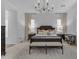 Main bedroom with a chandelier, large bed, neutral colors, and natural light at 3502 E Hazeltine Way, Queen Creek, AZ 85142