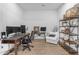 Spacious home office with multiple monitors and a cozy sitting area offers a productive and comfortable workspace at 3502 E Hazeltine Way, Queen Creek, AZ 85142
