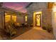 Inviting outdoor patio with comfortable seating, an umbrella, and lush potted plants, perfect for relaxing and entertaining at 3502 E Hazeltine Way, Queen Creek, AZ 85142