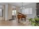 Sunlit piano room featuring a grand piano with elegant curtains and view to the backyard at 3502 E Hazeltine Way, Queen Creek, AZ 85142
