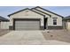 Charming single-story home featuring a neutral palette, spacious garage, and well-maintained landscaping at 35540 N Breezy Ln, San Tan Valley, AZ 85140