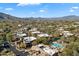 Community aerial featuring well-maintained desert landscaping and a sparkling pool against a mountain backdrop at 36601 N Mule Train Rd # B14, Carefree, AZ 85377