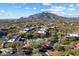 Aerial view showcasing community layout with a pool, well-maintained landscaping, and surrounding desert scenery at 36601 N Mule Train Rd # B14, Carefree, AZ 85377