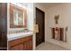 Bathroom featuring a decorative mirror and cabinet, white countertops, and elegant fixtures at 36601 N Mule Train Rd # B14, Carefree, AZ 85377