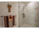 Bright, renovated shower featuring decorative tile accents and glass enclosure at 36601 N Mule Train Rd # B14, Carefree, AZ 85377
