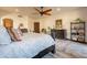 Bedroom with wooden floors, a ceiling fan, wooden furniture, a large rug, and ample light at 36601 N Mule Train Rd # B14, Carefree, AZ 85377
