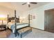 Bedroom featuring a four-poster bed, soft carpet, a ceiling fan and a wooden entry door at 36601 N Mule Train Rd # B14, Carefree, AZ 85377