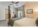 Bedroom with a four-poster bed, soft carpet, and view to a bathroom and through sliding glass doors at 36601 N Mule Train Rd # B14, Carefree, AZ 85377