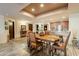 Open dining area featuring a rustic table and chairs near the kitchen and beautiful decor at 36601 N Mule Train Rd # B14, Carefree, AZ 85377