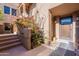 Inviting entrance with desert landscaping, stairs to upper level and front door at 36601 N Mule Train Rd # B14, Carefree, AZ 85377