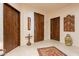 Inviting entryway with tile flooring, wooden doors, and decorative elements at 36601 N Mule Train Rd # B14, Carefree, AZ 85377