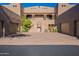 Inviting home exterior featuring a two-car garage, gated entry, and meticulously maintained desert landscaping at 36601 N Mule Train Rd # B14, Carefree, AZ 85377