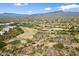 Expansive view of a pristine golf course surrounded by desert vegetation, set against a backdrop of rolling hills at 36601 N Mule Train Rd # B14, Carefree, AZ 85377
