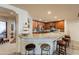 Open concept kitchen with granite countertops, wooden cabinets, stainless steel appliances and bar seating at 36601 N Mule Train Rd # B14, Carefree, AZ 85377