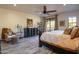Comfortable main bedroom with hardwood floors, ceiling fan, dresser and large bed at 36601 N Mule Train Rd # B14, Carefree, AZ 85377
