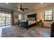 Inviting main bedroom with hardwood floors, ceiling fan, large bed and access to private balcony at 36601 N Mule Train Rd # B14, Carefree, AZ 85377