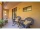 Covered patio with wicker chairs, pillows, and view of exterior at 36601 N Mule Train Rd # B14, Carefree, AZ 85377