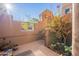 Private patio features vibrant bougainvillea, complemented by stylish tile accents at 36601 N Mule Train Rd # B14, Carefree, AZ 85377