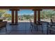 Covered patio view overlooks pool, with outdoor seating framed by substantial pillars and lush desert vegetation at 36601 N Mule Train Rd # B14, Carefree, AZ 85377