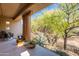 Relaxing outdoor patio showcasing desert landscaping and mature trees at 36601 N Mule Train Rd # B14, Carefree, AZ 85377