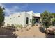 Modern white home featuring desert landscaping and access to an outdoor patio at 3811 N 64Th St, Scottsdale, AZ 85251