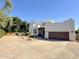 Modern home exterior with a large driveway and well-maintained landscaping at 3811 N 64Th St, Scottsdale, AZ 85251