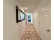 Inviting hallway featuring a decorative rug and a large mirror creating depth at 3811 N 64Th St, Scottsdale, AZ 85251
