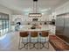 Modern white kitchen with large island, stainless steel appliances, and bar seating area at 3811 N 64Th St, Scottsdale, AZ 85251