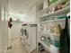 Bright laundry room features modern washer and dryer with plenty of storage for supplies at 3811 N 64Th St, Scottsdale, AZ 85251