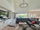 Spacious living room with vaulted ceiling, modern sectional sofa, and sliding glass doors to outdoor patio at 3811 N 64Th St, Scottsdale, AZ 85251