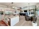 Open concept kitchen and living room with stainless steel appliances, modern lighting, and neutral finishes at 3811 N 64Th St, Scottsdale, AZ 85251