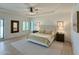 Bright bedroom with a tray ceiling, neutral decor, and light hardwood floors at 3811 N 64Th St, Scottsdale, AZ 85251