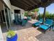 Inviting covered patio features outdoor dining and lounge seating, next to sparkling pool, and brick flooring at 3811 N 64Th St, Scottsdale, AZ 85251