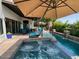 Relax in the backyard oasis with pool, spa, waterfall features, and a covered patio for outdoor living at 3811 N 64Th St, Scottsdale, AZ 85251