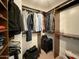 Organized walk-in closet with ample storage for clothing, luggage, and personal items at 3811 N 64Th St, Scottsdale, AZ 85251