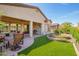 Expansive backyard featuring a covered patio, artificial turf, and stone garden for outdoor enjoyment at 4086 E Narrowleaf Dr, Gilbert, AZ 85298