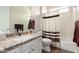 Well-lit bathroom with granite countertop, white cabinetry, a shower, and modern fixtures at 4086 E Narrowleaf Dr, Gilbert, AZ 85298