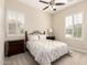 Cozy bedroom with neutral tones, plantation shutters, a ceiling fan, and comfortable furnishings at 4086 E Narrowleaf Dr, Gilbert, AZ 85298