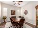 Elegant dining room featuring a wood table and chairs, stylish lighting, and plantation shutters at 4086 E Narrowleaf Dr, Gilbert, AZ 85298