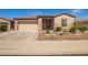 Charming single-story home with a two-car garage, desert landscaping and a tile roof at 4086 E Narrowleaf Dr, Gilbert, AZ 85298